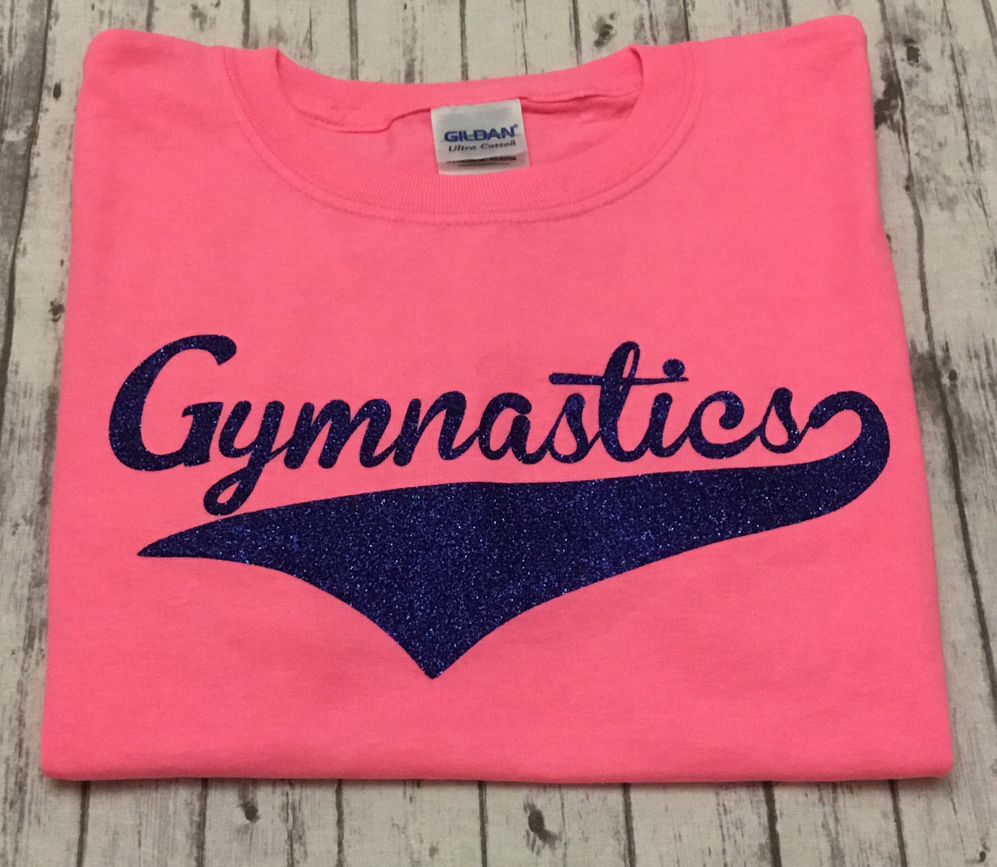 Neon Pink Gymnastics T-shirt with Royal Blue Glitter Vinyl - Sandy's Bling & Embroidery