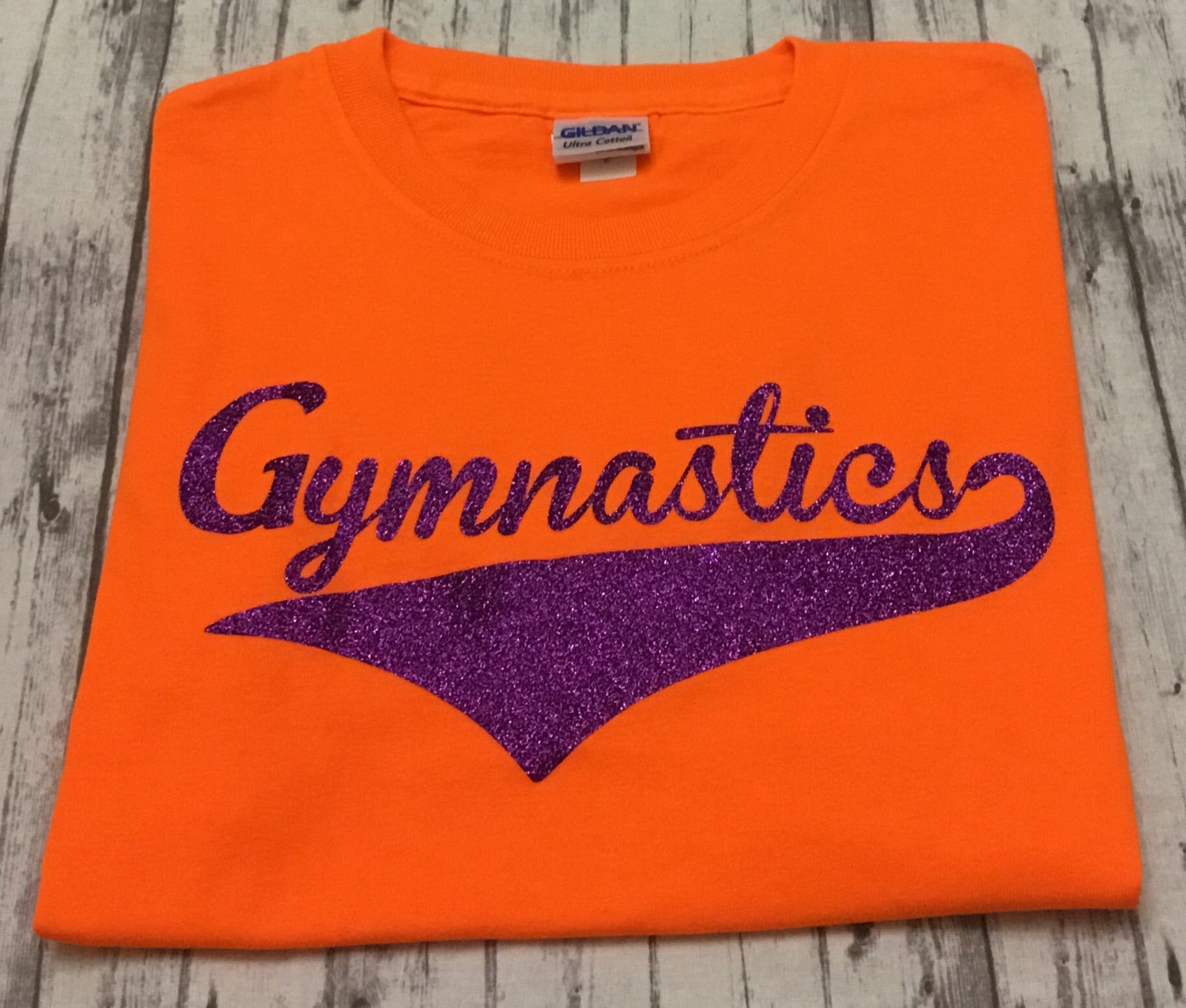 Neon Orange Gymnastics T-shirt with Purple Glitter Vinyl - Sandy's Bling & Embroidery